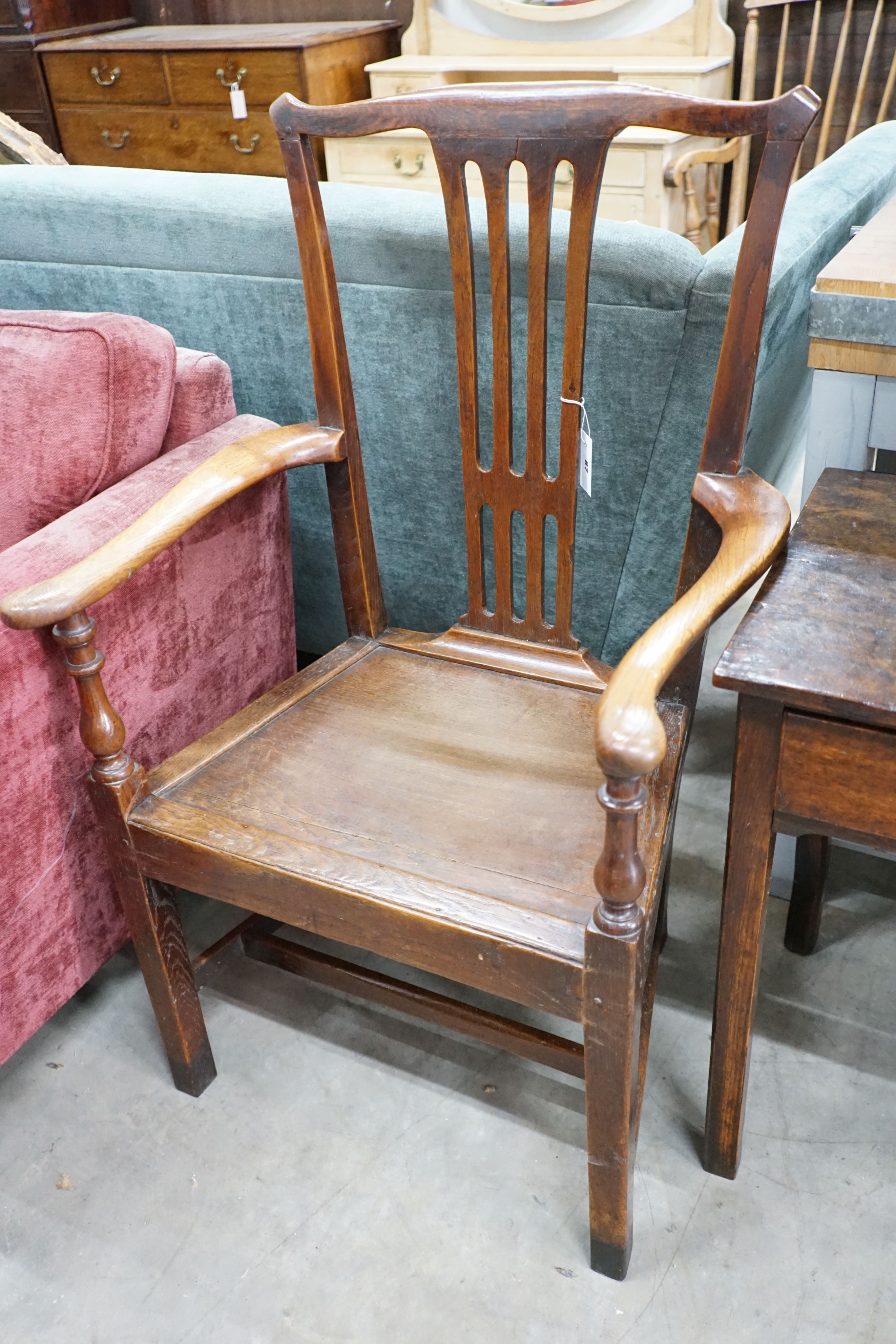 A large George III oak wood seat elbow chair, width 68cm, depth 47cm, height 112cm